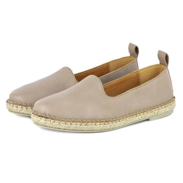 Pair of beige espadrille shoes on a white background