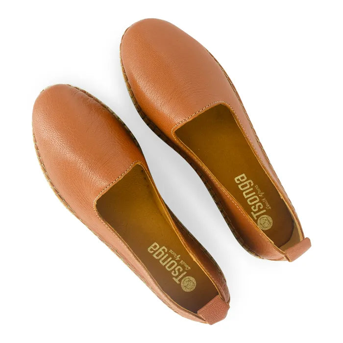 Pair of tan leather shoes on a white background
