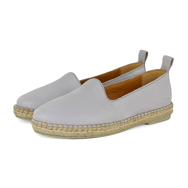 Light grey espadrille shoe with beige soles on a white background