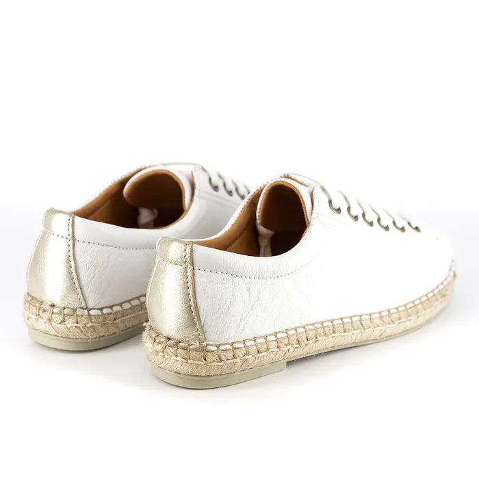 Pair of white sneakers with gold accents on a white background