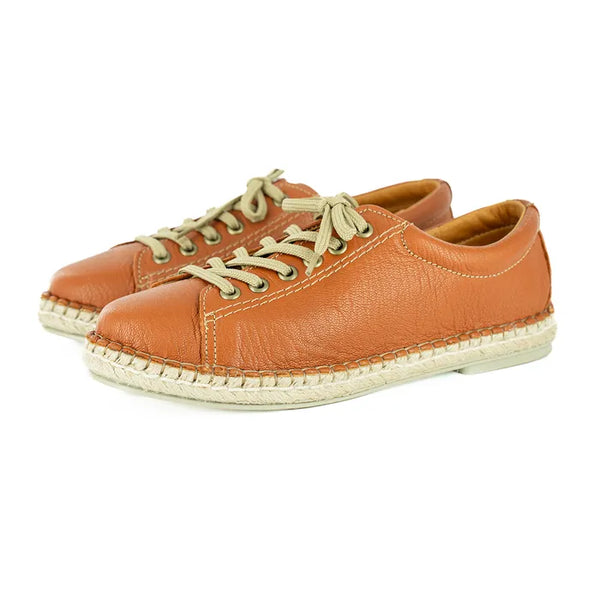 Pair of brown leather shoes with espadrille soles on a white background