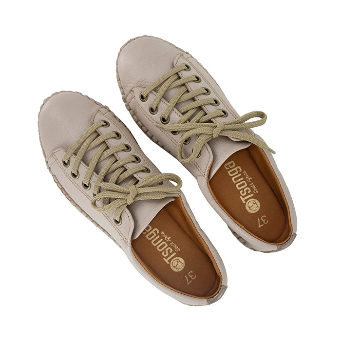 Pair of beige sneakers with brown soles on a white background