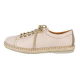 Beige sneaker with brown sole on a white background