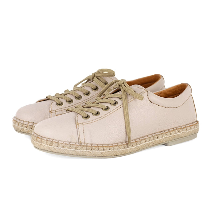Pair of beige espadrille sneakers on a white background