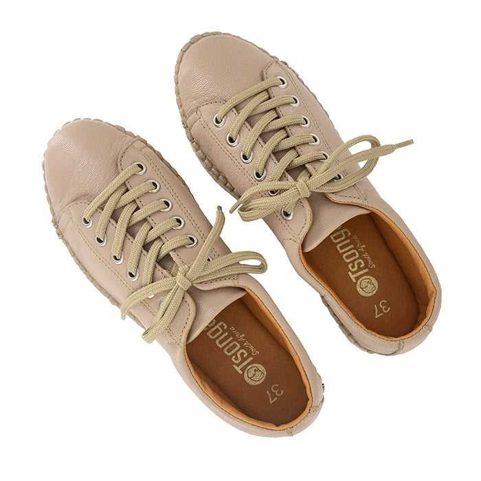 Pair of beige sneakers with laces on a white background