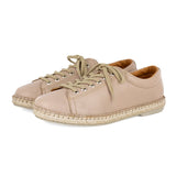 Pair of beige sneakers with espadrille soles on a white background