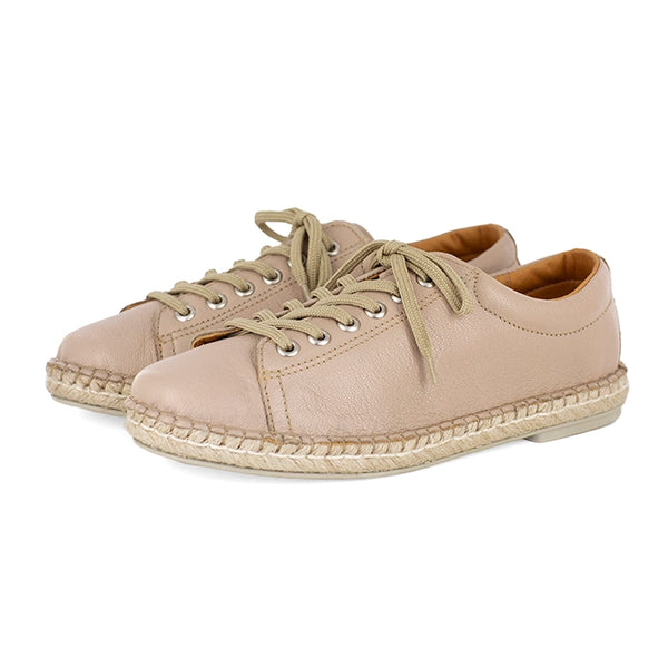 Pair of beige sneakers with espadrille soles on a white background