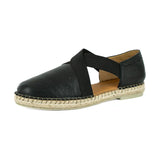 Black shoe with espadrille sole on a white background