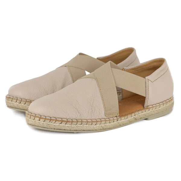 Pair of beige espadrille shoes on a white background