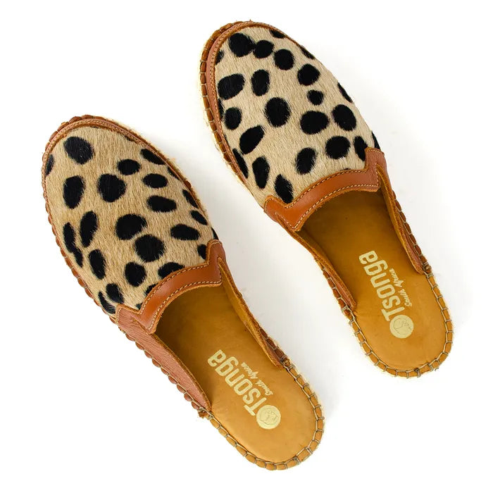 Pair of cheetah print mules with brown trim on a white background