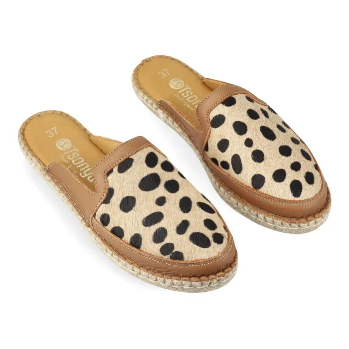 Pair of spotted print mules with brown trim on a white background
