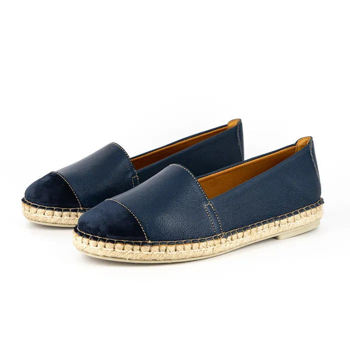 Pair of navy blue espadrilles with beige sole on a white background