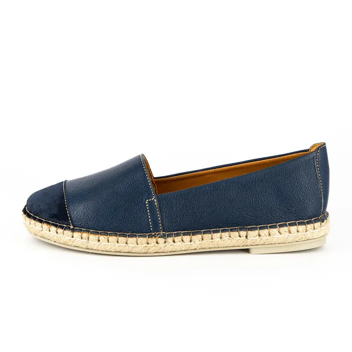 Blue espadrille shoe with off white sole on a white background
