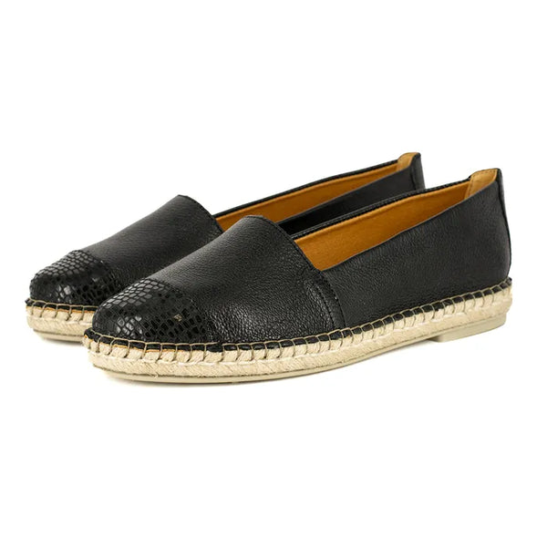Pair of black espadrilles on a white background