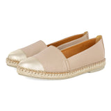 Pair of beige espadrilles with metallic cap-toe on a white background