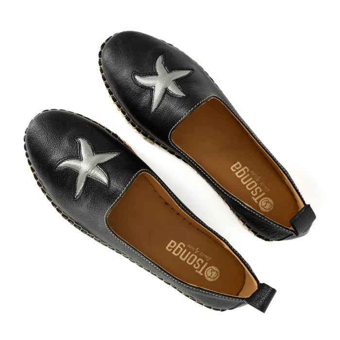 Black flats with star designs on a white background