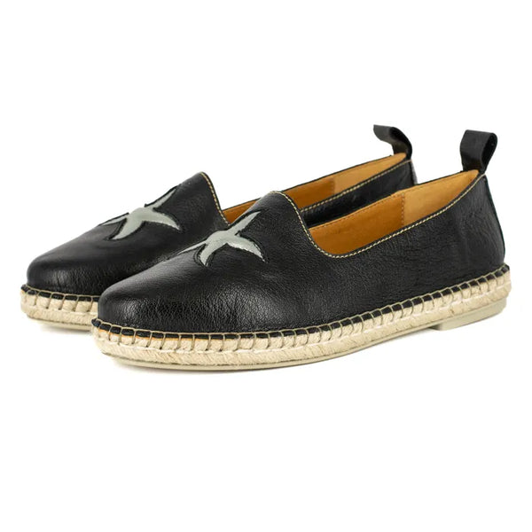 Black leather espadrilles with jute sole on a white background