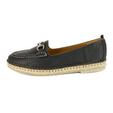Black loafer shoe with beige sole on a white background