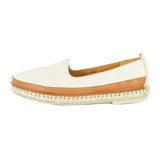 Cream slip-on shoe with brown trim on a white background