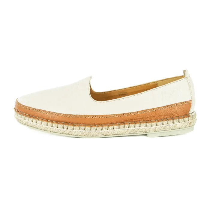 Cream slip-on shoe with brown trim on a white background