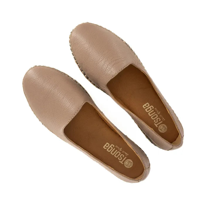 Pair of beige flat shoes with 'Tsonga' branding on a white background
