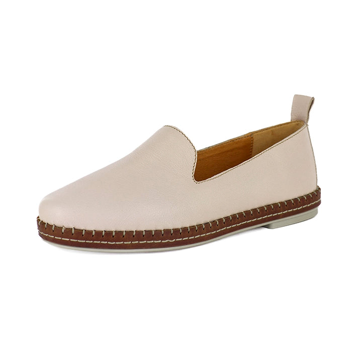 Beige slip-on shoe with brown sole on a white background