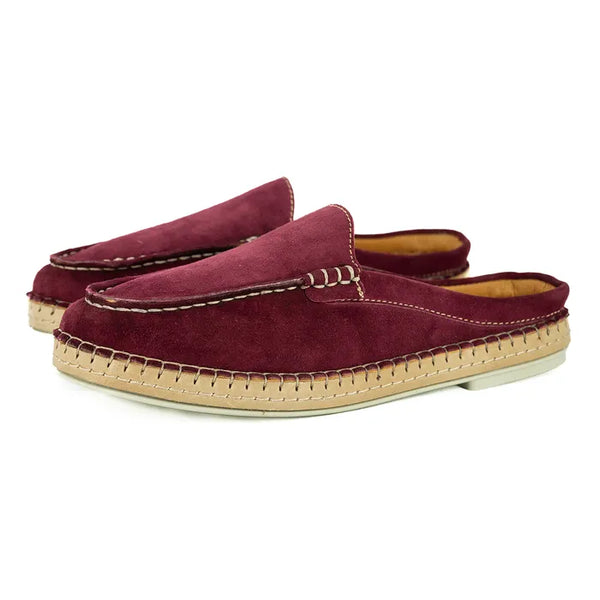 Pair of maroon espadrilles with beige sole on a white background