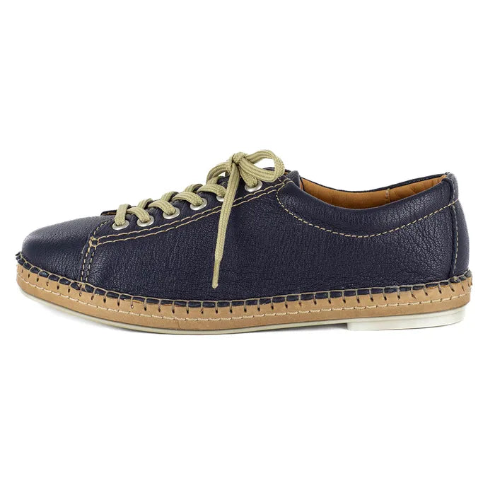 Navy blue shoe with beige sole on a white background