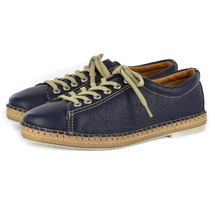 Pair of navy blue sneakers with beige laces and soles on a white background