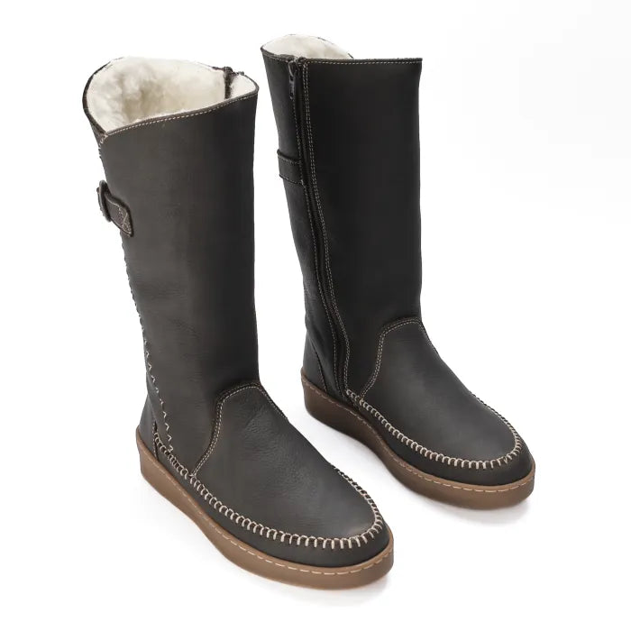 Pair of choc leather boots with white fur lining on a white background