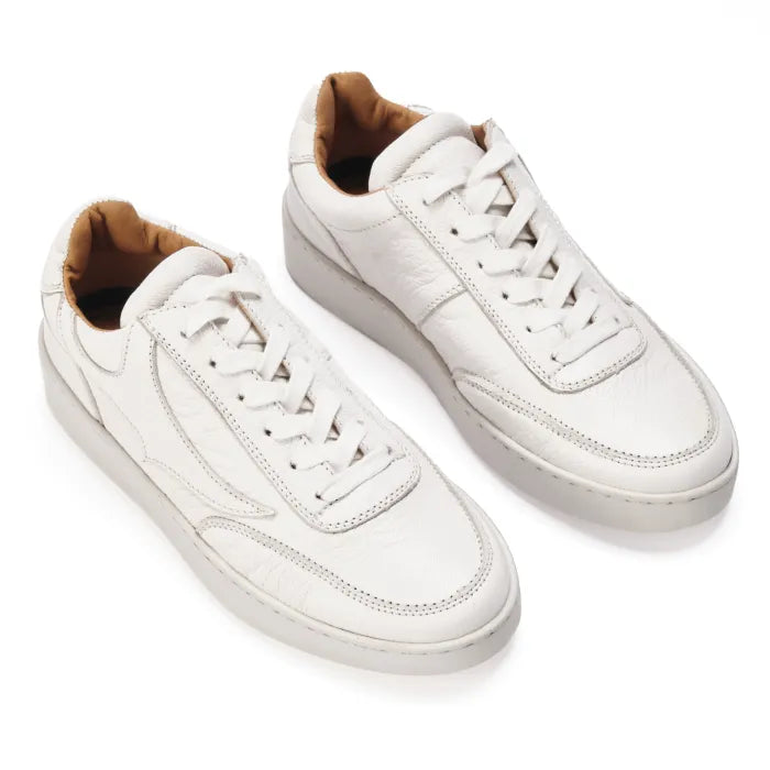 White sneakers with brown lining on a white background
