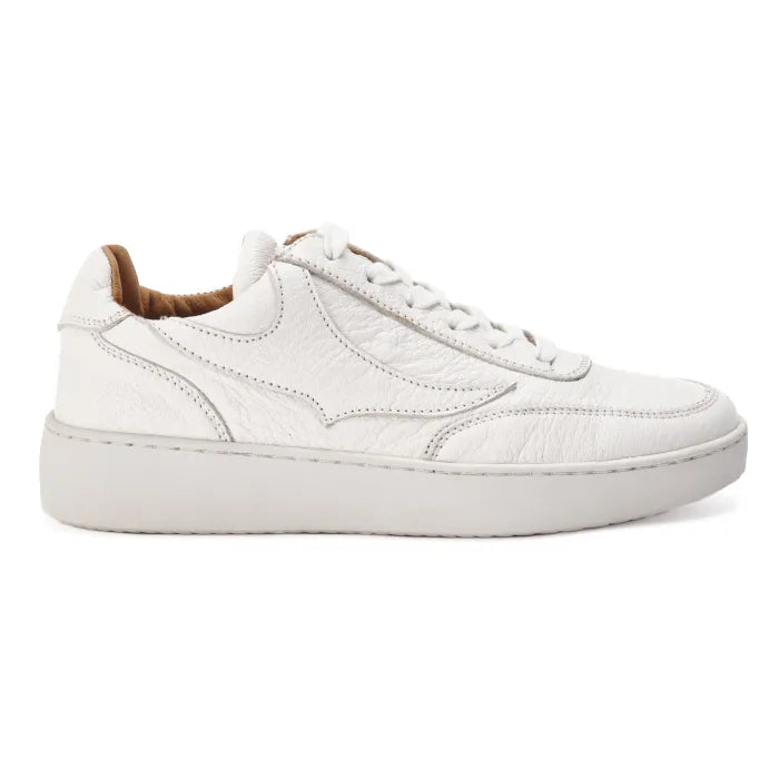 White sneaker with brown lining on a white background