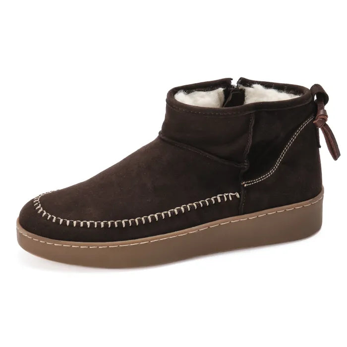 Brown suede ankle boot with white stitching on a white background