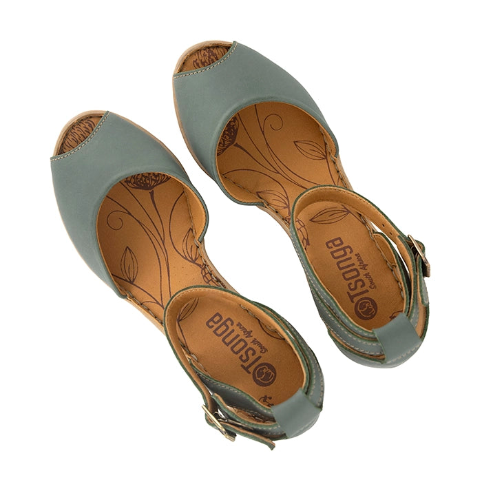 Pair of light green sandals with brown soles on a white background