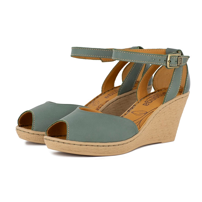 Green wedge sandals with beige sole on a white background