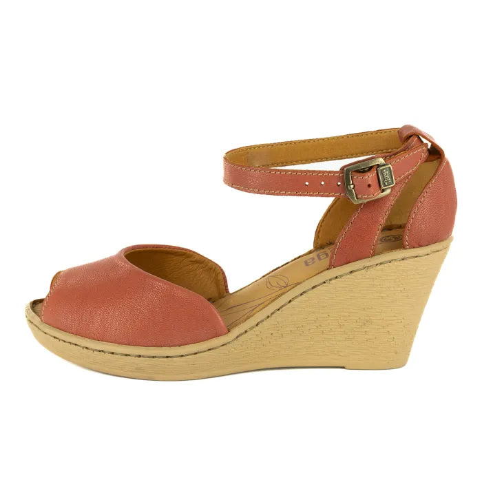 Coral wedge sandal with a wooden sole on a white background