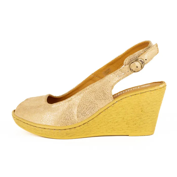 Gold wedge sandal on a white background