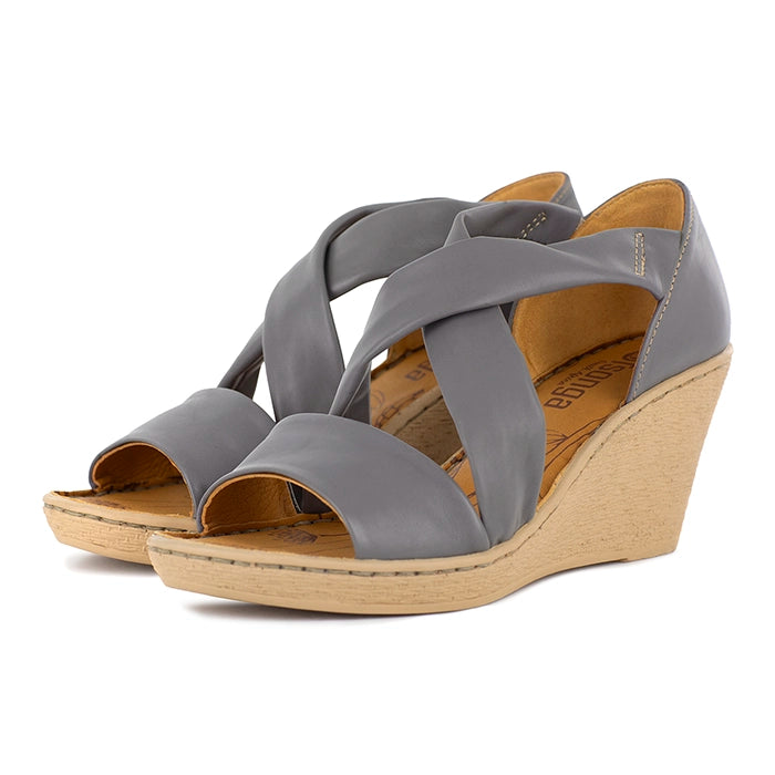 Grey wedge sandals with a beige wedge sole on a white background