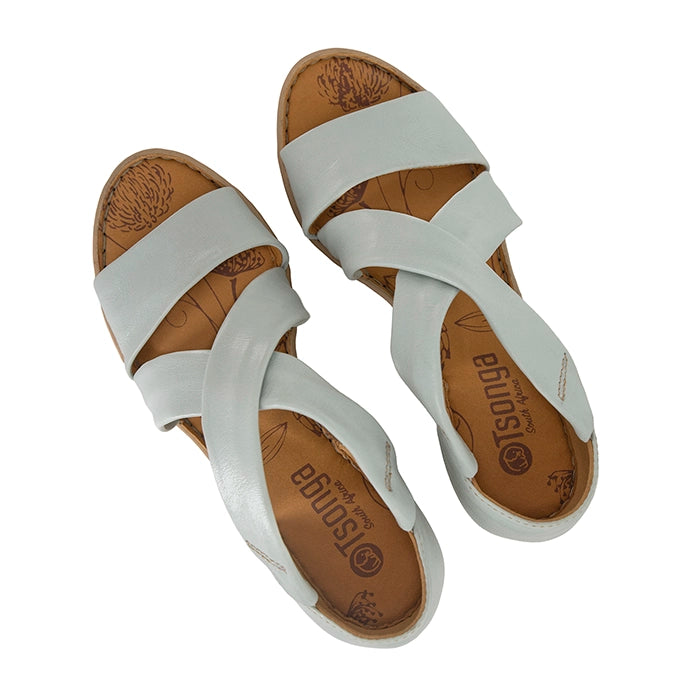 Pair of pale blue sandals with brown soles on a white background