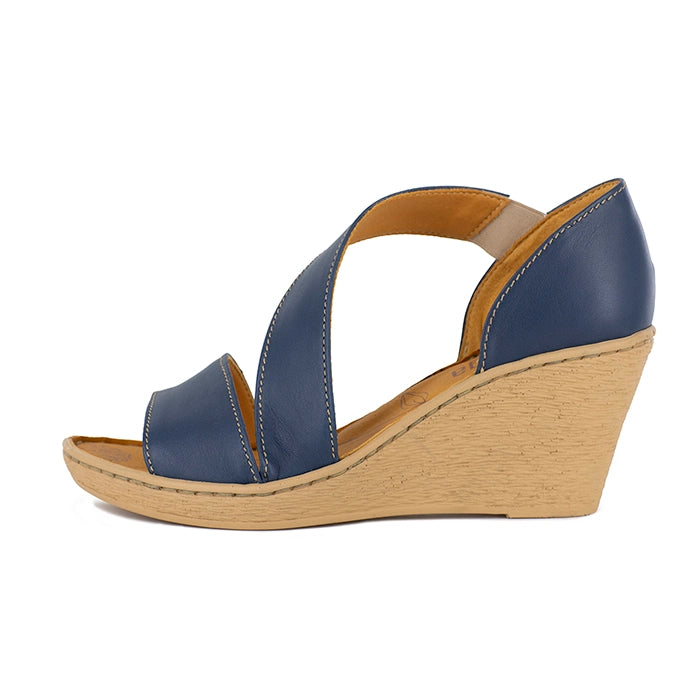 Blue wedge sandal with beige sole on a white background