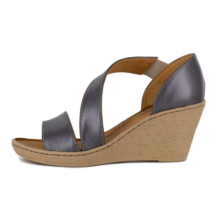 Wedge sandal with metallic silver straps and beige wedge sole on a white background