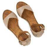 Pair of beige sandals with floral patterns  on sock on a white background