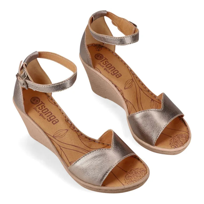 Pair of bronze wedge sandals with 'Tsonga' branding on a white background
