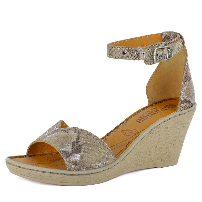 Wedge sandal with glittery strap and beige sole on a white background