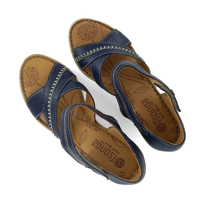 Pair of blue sandals with brown soles on a white background