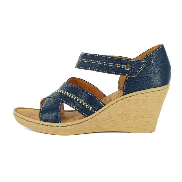 Blue wedge sandal with a beige sole on a white background
