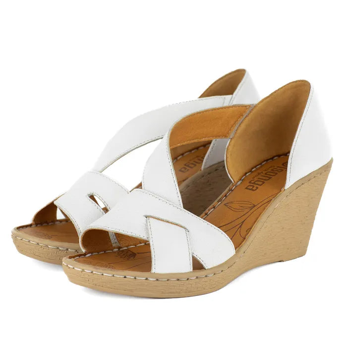 White wedge sandals with beige soles on a white background