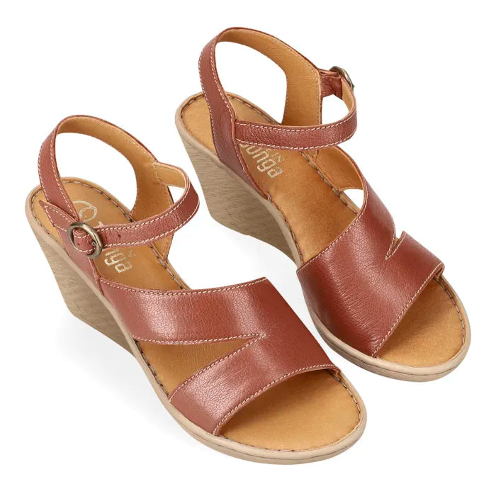 A pair of women's wedge sandals in brown leather with adjustable ankle straps and open toes, displayed on a clean white background.