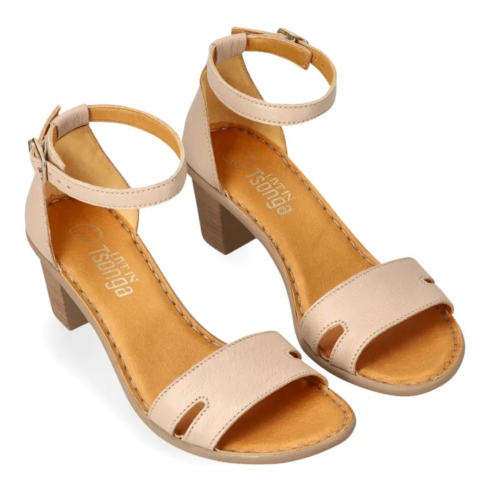 A pair of women's block-heel sandals in a light beige color, featuring cutout details on the toe strap and ankle straps with buckle closures. The brand name 'Tsonga' is visible on the insole.