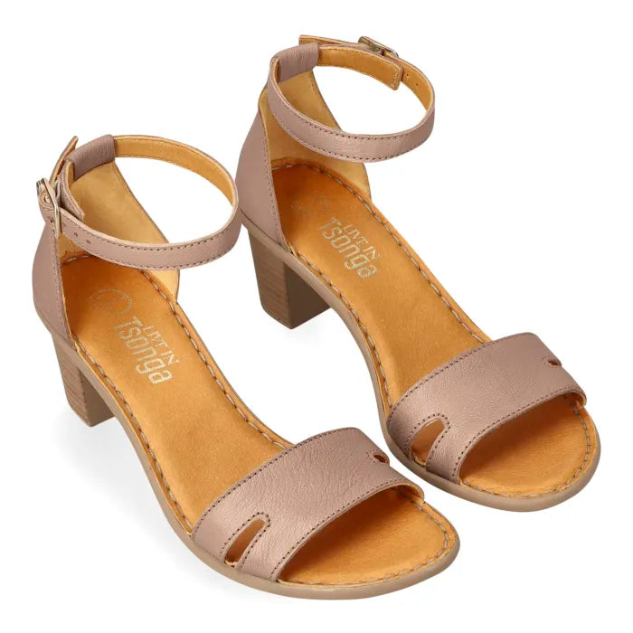 A pair of women's block-heel sandals in a beige color, featuring a double-strap design with cutouts and an adjustable ankle strap. The insoles are a contrasting tan color with the brand name 'Tsonga' printed on them, set against a plain white background.